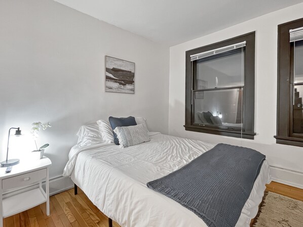Plush queen bed with gorgeous hardwood floors