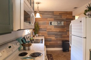The kitchen has all the dining and cooking tools you'll need.