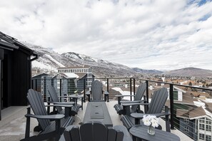 4th level deck with adirondack seating around a gas fire pit