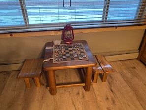 Checkers table facing out one of the front bay windows. 