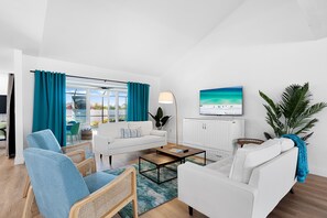 Living room with full size Murphy bed and smart TV, bring your streaming log ins