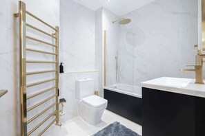 Modern bathroom with plush towels, luxury soaps & built-in toilet bidet.