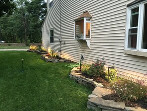 Green grass and lovely flowers that surround the home