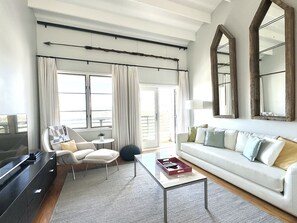 OPEN LIVING WITH HIGH CEILINGS AND BALCONY ACCESS