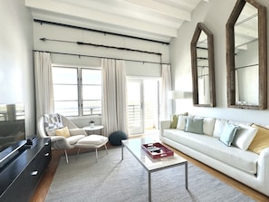 OPEN LIVING WITH HIGH CEILINGS AND BALCONY ACCESS