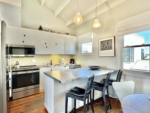 FULLY EQUIPPED KITCHEN WITH BAR TOP SEATING FOR THREE