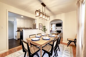 Dining area for 6 with an extra chair and beautiful lighting fixture