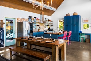 Beautiful kitchen stocked with appliances and utensils needed to enjoy meals.