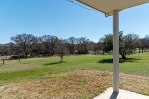 View from porch towards bluebonnets and pond. 