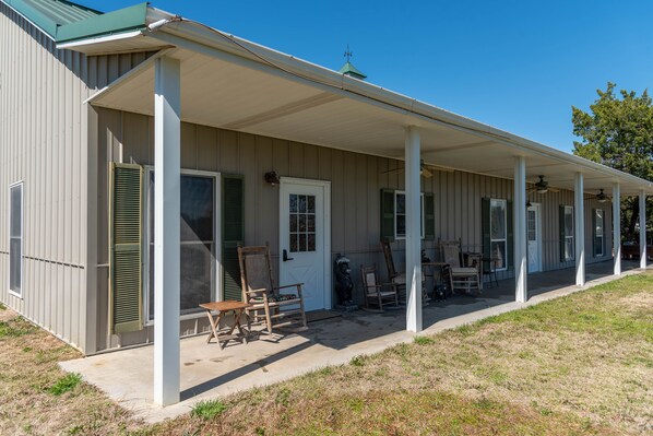 Covered porch with rocking chairs.