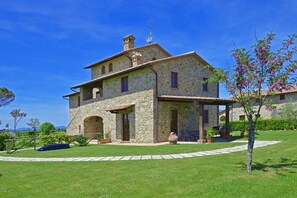 The tipical tuscan house surrounded by greenery
