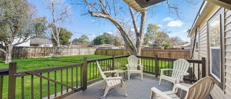 Step outside and unwind in the backyard deck.  Relax in style with a view of the grassy yard.   It's the ultimate relaxation spot!  