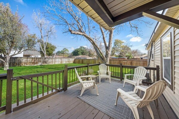 Step outside and unwind in the backyard deck.  Relax in style with a view of the grassy yard.   It's the ultimate relaxation spot!  