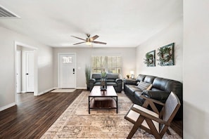 The cozy living area with beautiful wood flooring, natural lighting, a comfy couch, and a stylish coffee table will welcome you once you enter our home!