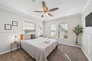 Experience a restful night's sleep in the queen-sized bed of this bedroom, complemented by a modern ceiling fan—a perfect combination for a rejuvenating rest!