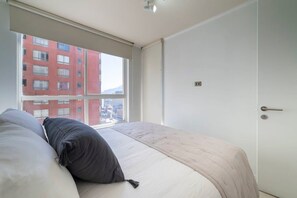 Despierta renovado con la luz natural y la suave brisa de Santiago en este dormitorio 