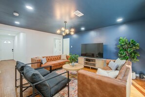 This living room offers the perfect balance of warmth, charm, and excitement with its stylish speakeasy design and layout!