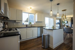 fully stocked main floor kitchen. gas stove, dishwasher