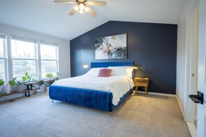 Second floor primary bedroom with comfy king bed and en suite bath.