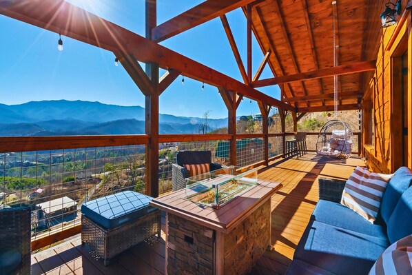 Second floor deck: seating area, fire pit, 2 egg swing, bar with 4 chairs, cornhole game, and breathtaking views