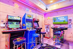 Downstairs basement area is a kid's dream with 4 arcades, PS5, led lighting & signs, ball prize machine, claw machine, a jelly bean dispenser, and more!
