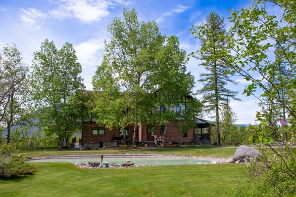 East Facing Front of house with cement pond. 