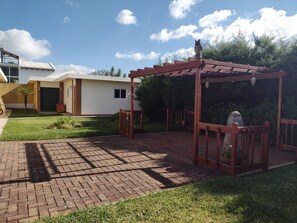 Outdoor patio area with fire pit, BBQ, and patio furniture