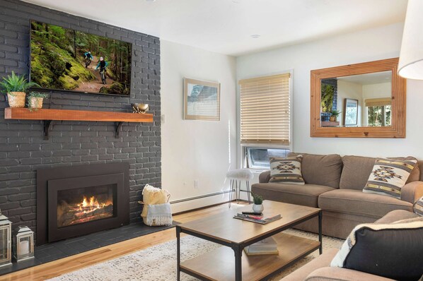 Comfortable living space with fireplace, smart TV, and pullout couch.
