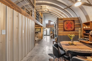 Open living, dining, eating, gaming area with 2 private bedrooms