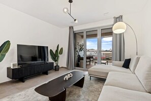 Stream your favorite shows in our chic living area with ample seating and stylish decor for a relaxing evening in.