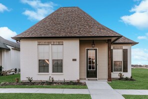 Admire the exterior view of a property built in 2022 and maintained to perfection. Just one mile away from a newly established golf course, this home offers the ideal blend of comfort and leisure.