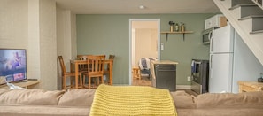 This inviting living room is perfect for relaxing after a long day. With comfortable seating, a flat-screen TV, and a dining table, it's the ideal space to unwind and enjoy your stay.