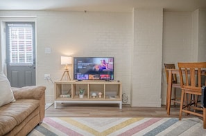 With comfortable seating, a flat-screen TV, and a dining table, it's the ideal space to unwind and enjoy your stay near Downtown, Columbus.