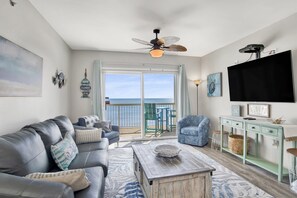 Living room with a leather sleeper sofa, 3 armchairs a wall mounted smart TV and a breathtaking Gulf view!