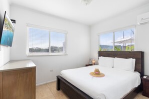 Distinguished bedroom of the 2BR condo in Noord Aruba - Smart TV and Netflix - Cozy retreat with a plush bed, perfect for relaxation - EnSite bathroom for privacy and convenience