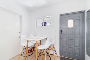Eclat Dining Area of the 2BR condo in Noord Aruba - 4 Persons Dining - Quality materials, such as a sleek dining table and comfortable chairs - Open layout seamlessly connecting the dining area to the kitchen