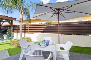 Cozy private patio of the Apartment in Noord Aruba near Palm Beach - Enjoy stunning surroundings while you dine - Refreshing Environment - 4 Persons Dining - Shade for sensitive guests