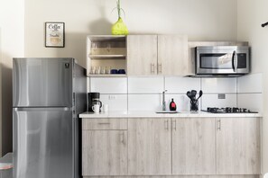 Well-Designed Kitchen of the Apartment in Noord Aruba - Integrated appliances for a seamless and stylish appearance - Thoughtful placement of kitchen essentials for easy access - Coordinated kitchen decor for a polished and inviting atmosphere