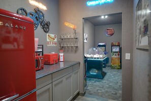 Snack bar with mini fridge, microwave, air popcorn popper, and hotdog warmer.