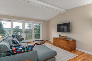 TV room with doors to outside deck