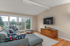 TV room with doors to outside deck