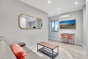 Sunshine streams through the window, casting a warm glow on this inviting living room.