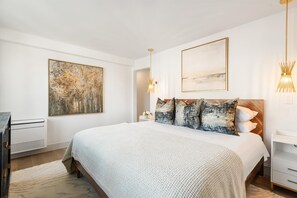 Primary bedroom with king size bed and luxury linens that are professionally laundered and pressed