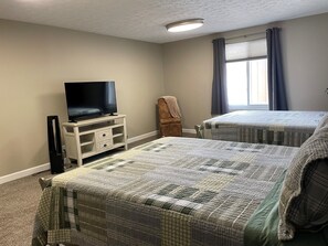 Bedroom 1: 2 Queen beds, TV, chair
