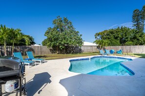 Pool with outdoor lounge chairs and tables