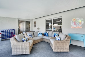 Lanai conversation set showing outdoor cooler and Connect 4 foosball games