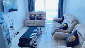 Bright living room very spacious with very comfy chairs and smart TV.water dispenser and many more