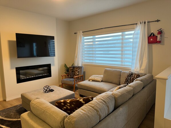 Living room with smart tv and fire place. 