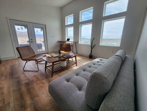 Bright and open living room with natural light pouring in from large windows.