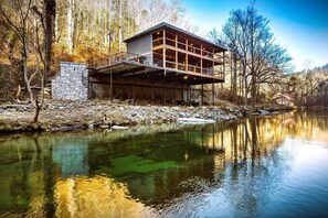 This might be THE ONLY Upscale WATERFRONT cabin perched right above the famous Little Pigeon River in Gatlinburg, TN - where the sound of rushing river is your daily soundtrack. A truly unforgettable stay awaits! Capture and bring the memories home!